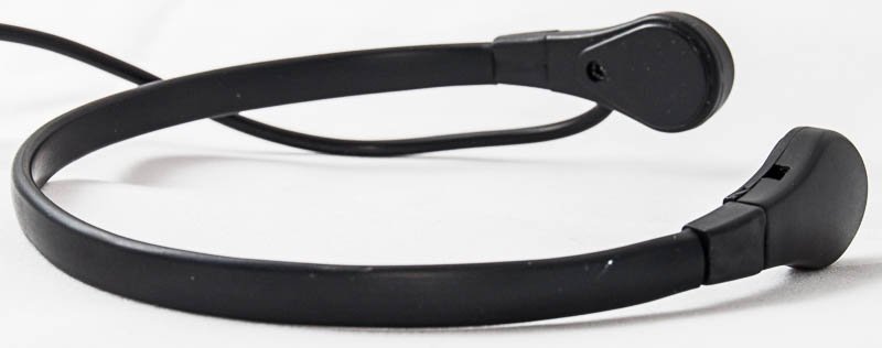 Black wired headset with a thin, flexible band and sleek earpieces, resting on
a white surface.