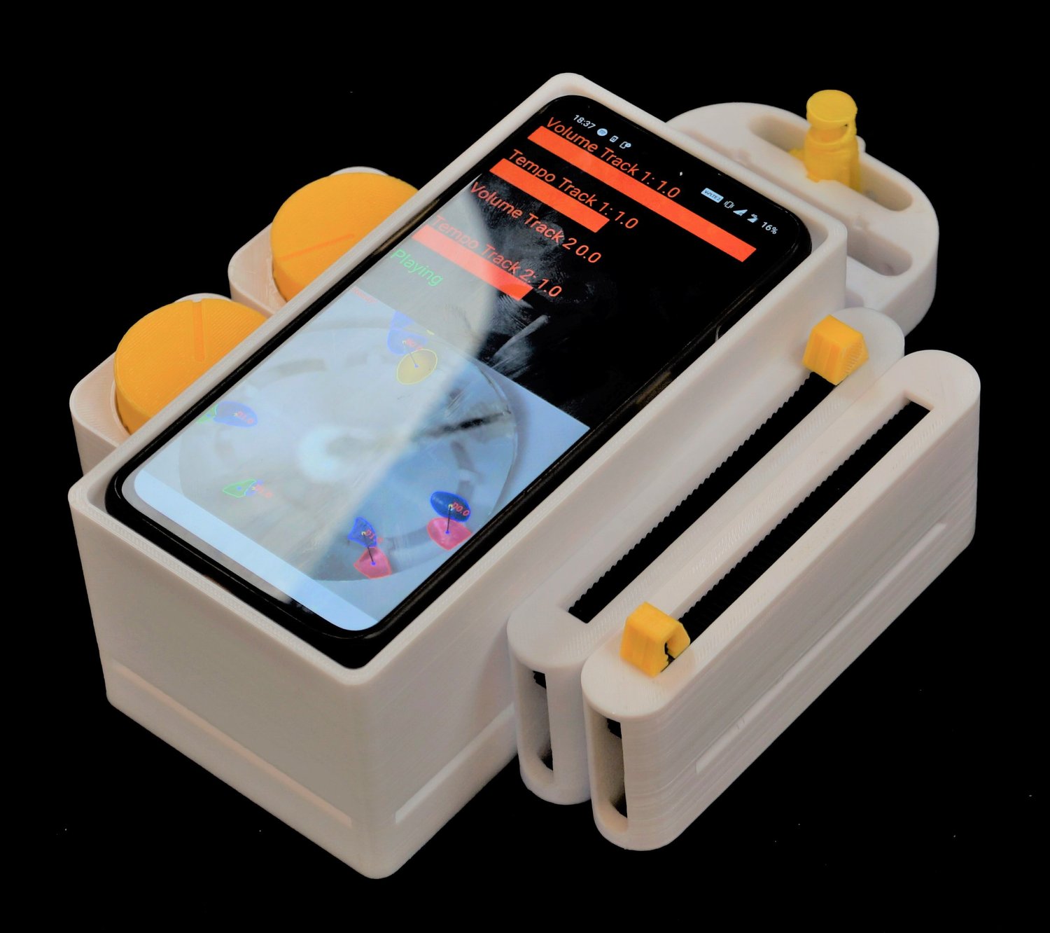 A smartphone in a white, 3D-printed case with yellow knobs displays a music
interface. The design suggests a modern DIY
project.
