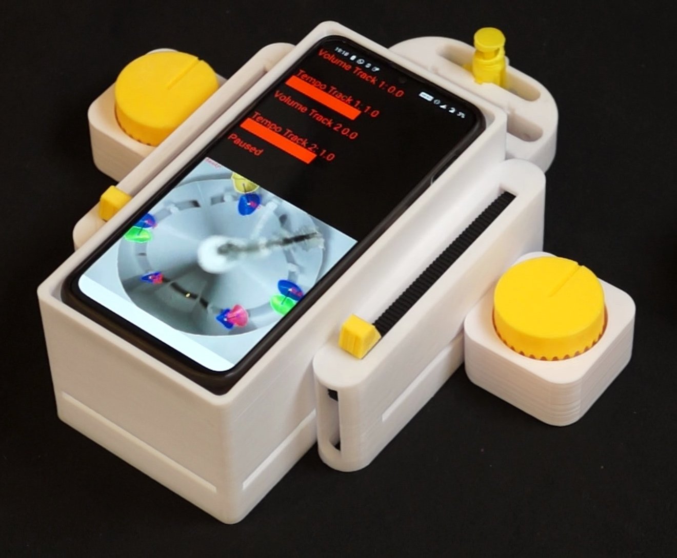 Futuristic device with a smartphone, displaying software controls, is nestled
in a white 3D-printed case. Yellow knobs suggest
adjustability.