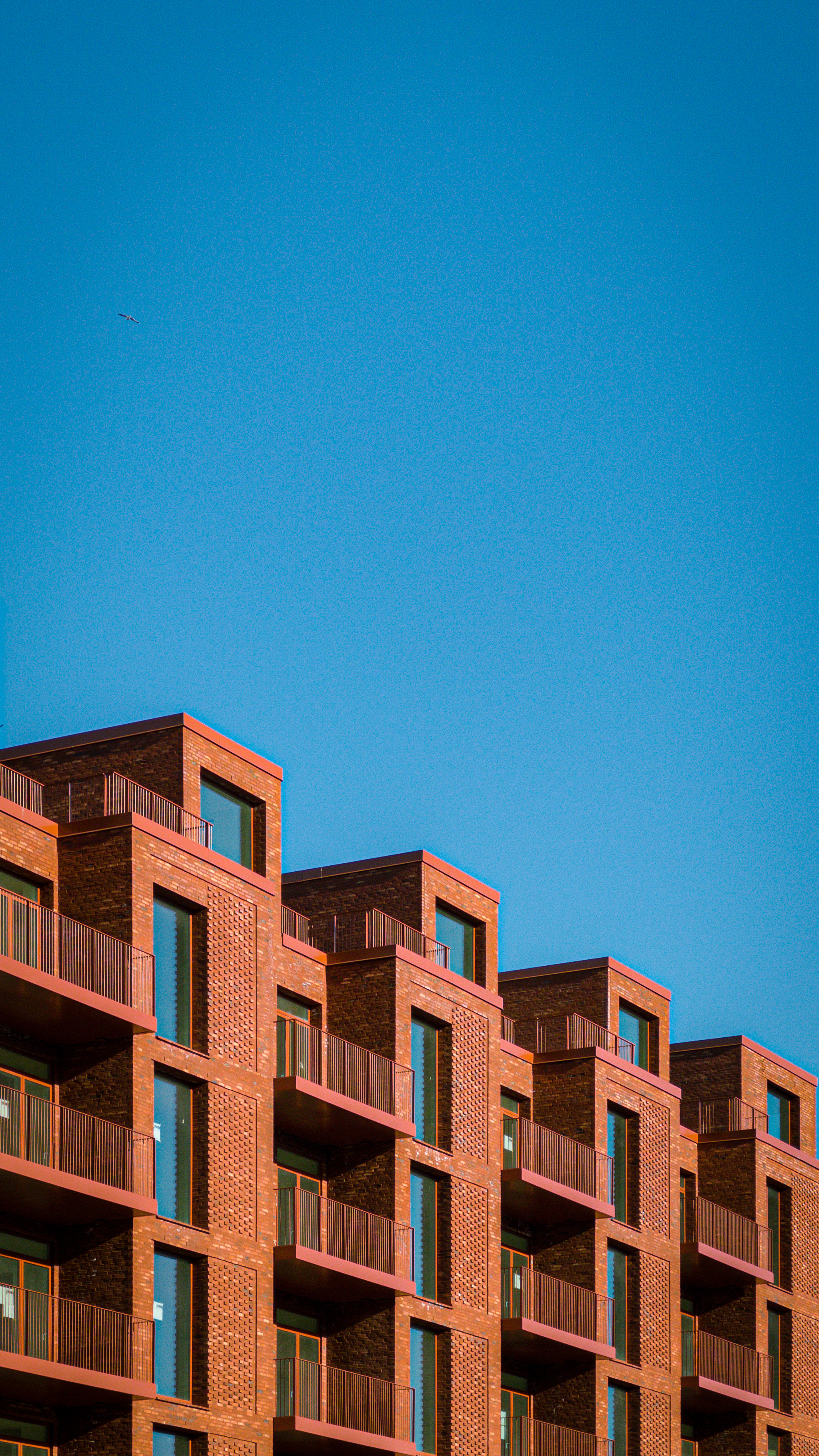 Modern brick apartment building under a clear blue
sky